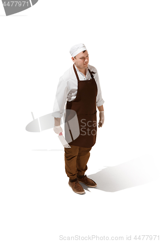 Image of Serious butcher posing with a cleaver isolated on white background