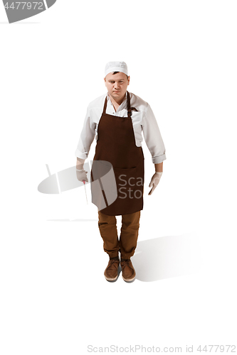 Image of Serious butcher posing with a cleaver isolated on white background