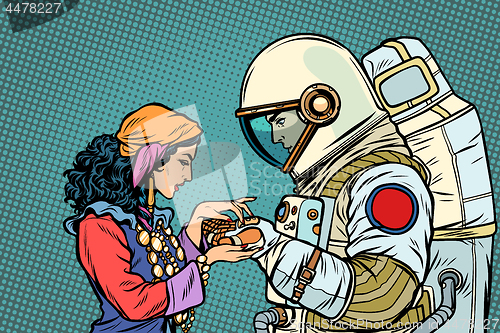 Image of The fortune teller, and an astronaut. Palmistry by hand