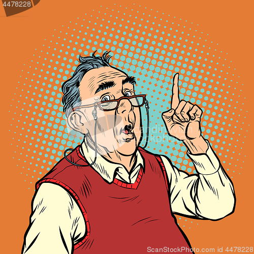 Image of surprise elderly man with glasses attention gesture index finger up