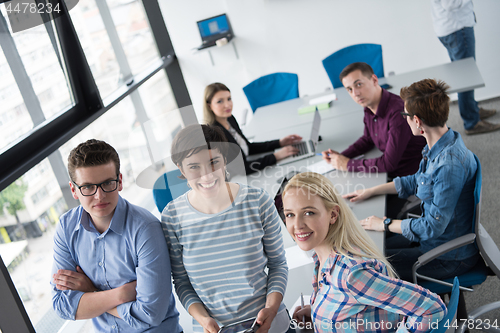 Image of group of Business People Working With Tablet in startup office