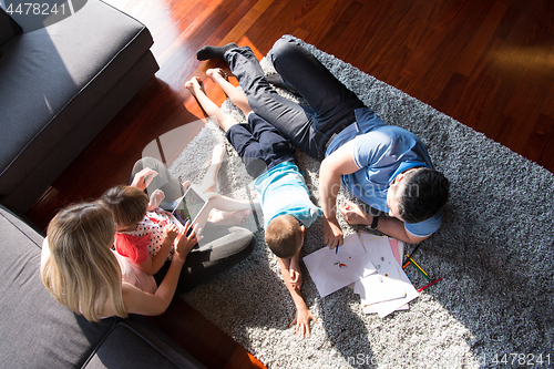 Image of young couple spending time with kids top view