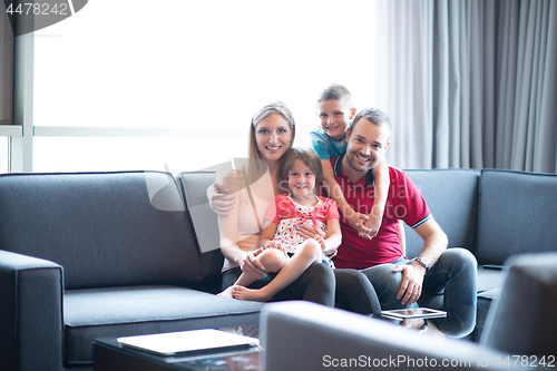 Image of happy young couple spending time with kids