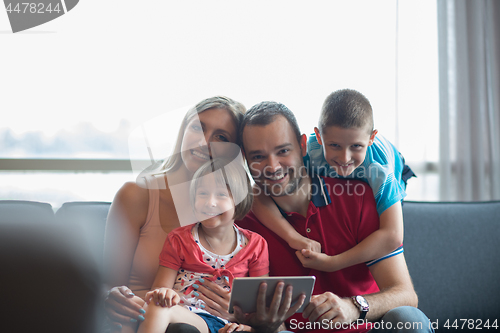 Image of happy young couple spending time with kids