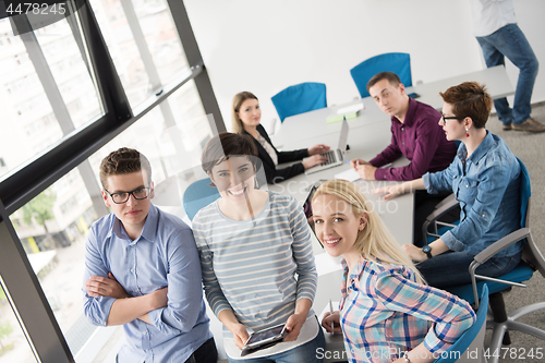 Image of group of Business People Working With Tablet in startup office