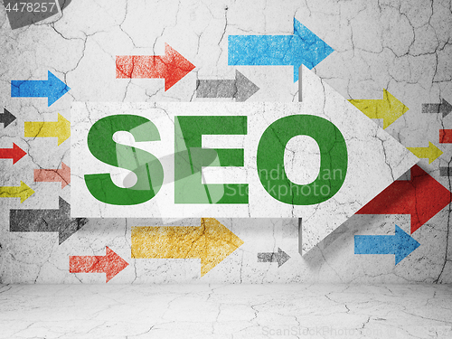 Image of Web design concept: arrow with SEO on grunge wall background