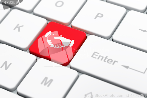 Image of Politics concept: Handshake on computer keyboard background