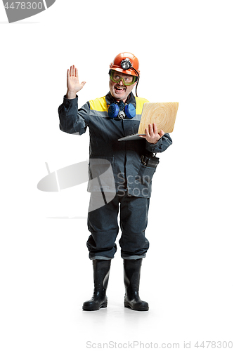 Image of The studio shot of happy senior bearded male miner standing at the camera with laptop on a white background.