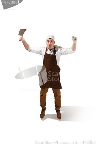 Image of Smiling butcher jumping with a cleaver isolated on white background