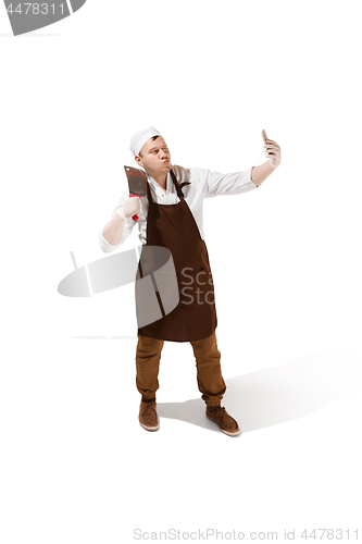 Image of Smiling butcher posing with a cleaver isolated on white background