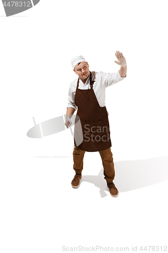 Image of Angry aggressive butcher posing with a cleaver isolated on white background