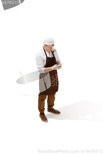 Image of Smiling butcher posing with a cleaver isolated on white background