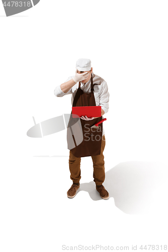 Image of Serious butcher posing with a laptop isolated on white background