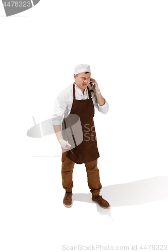 Image of Smiling butcher posing with a cleaver isolated on white background