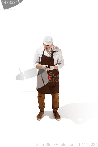 Image of Smiling butcher posing with a cleaver isolated on white background