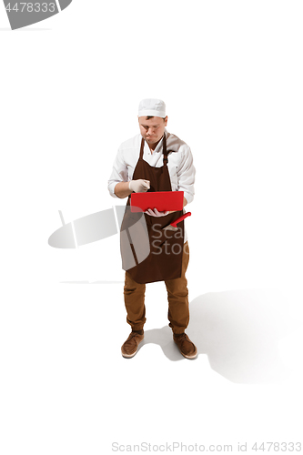 Image of Serious butcher posing with a laptop isolated on white background