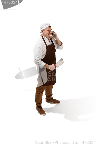 Image of Smiling butcher posing with a cleaver isolated on white background