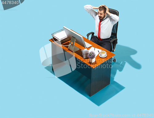 Image of Shot from above of a stylish business man working on a laptop.