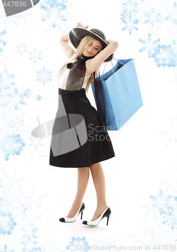 Image of blond in retro hat with blue shopping bag