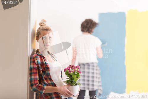 Image of happy young couple doing home renovations