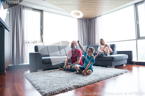 Image of Happy family playing a video game