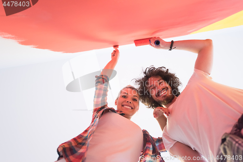 Image of couple painting interior wall