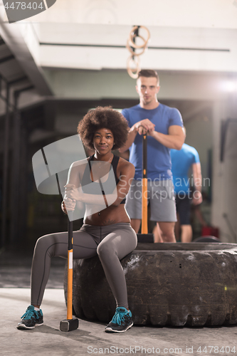 Image of multiethnic couple after workout with hammer