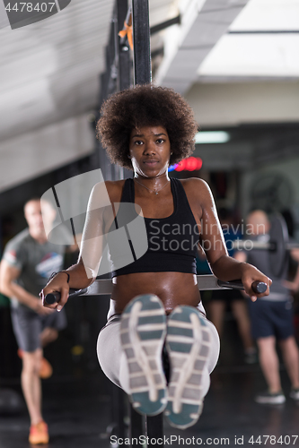 Image of black woman doing parallel bars Exercise
