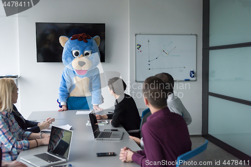 Image of boss dresed as bear having fun with business people in trendy of