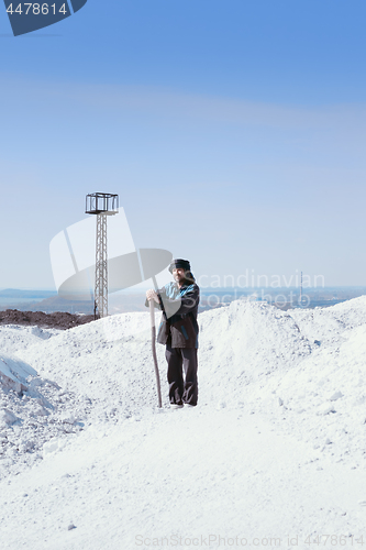 Image of Man In Ethnic Clothes Among The White Mounds Against The Mining 