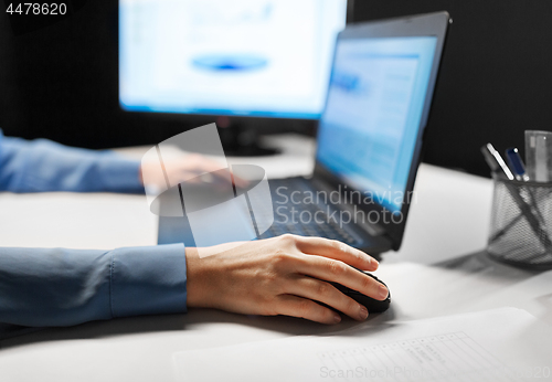 Image of close up of female hand using computer mouse