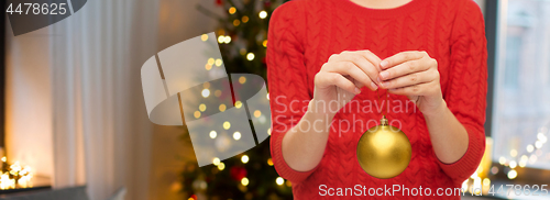 Image of close up of woman holding christmas ball