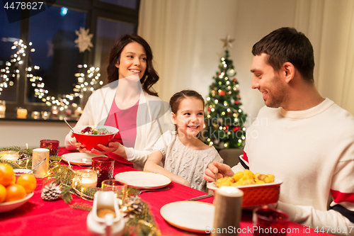 Image of happy family having christmas dinner at home