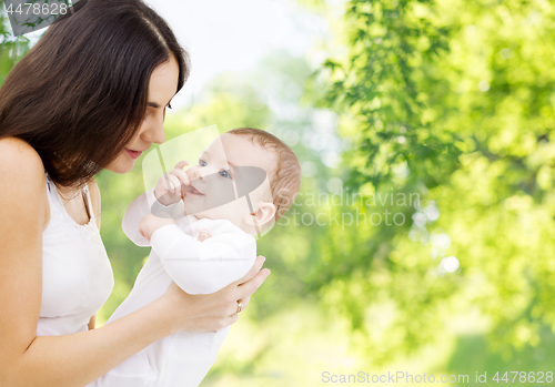 Image of mother with baby over green natural background