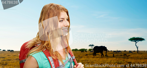 Image of happy woman with backpack over african savannah