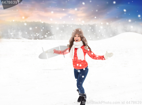 Image of happy woman in fur hat over winter background