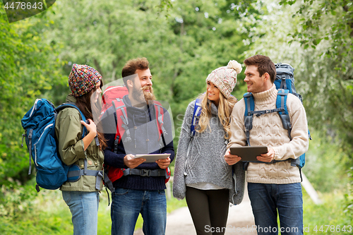 Image of friends or travelers with backpacks and tablet pc