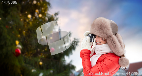 Image of woman with camera over christmas tree in tallinn