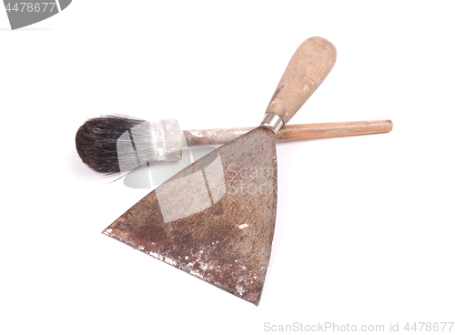 Image of Old paintbrush with a putty knife