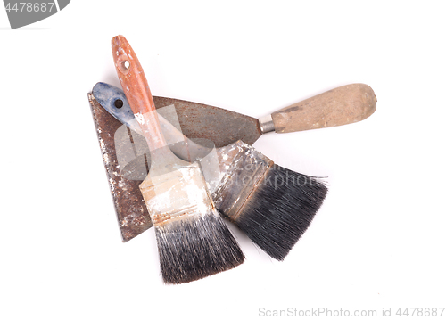 Image of Old paintbrushes with a putty knife