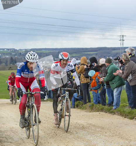 Image of Two Cyclists on a Dirty Road - Paris-Nice 2016