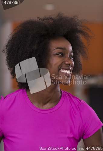 Image of afro american woman running on a treadmill