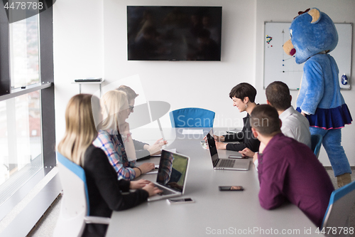 Image of boss dresed as bear having fun with business people in trendy of