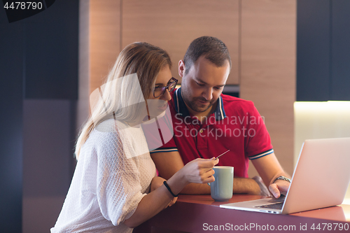 Image of happy young couple buying online