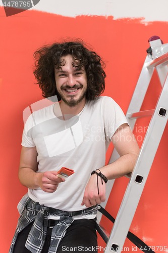 Image of man with funny hair over color background with brush