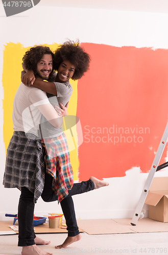 Image of Young happy multiethnic couple hugging