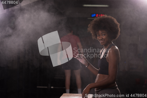 Image of black woman preparing for climbing workout