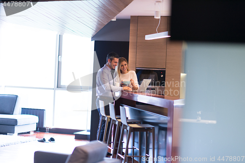 Image of A young couple is preparing for a job and using a laptop
