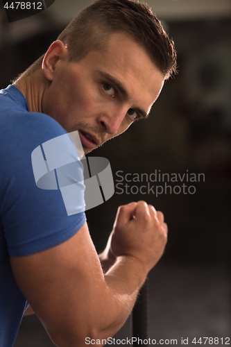 Image of man workout with hammer and tractor tire