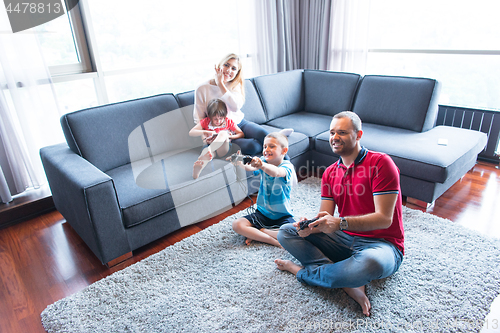 Image of Happy family playing a video game